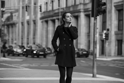 Full length of woman standing on street in city