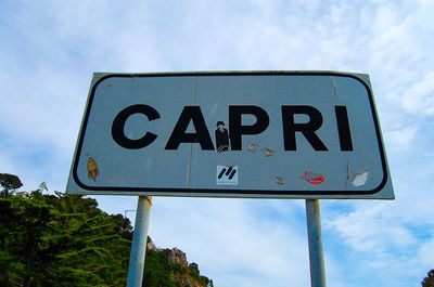 Low angle view of signboard against sky