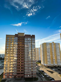 Buildings in city against blue sky