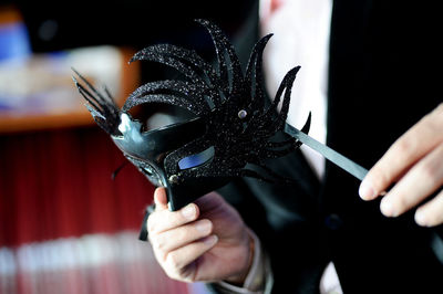 Close-up of person holding mask