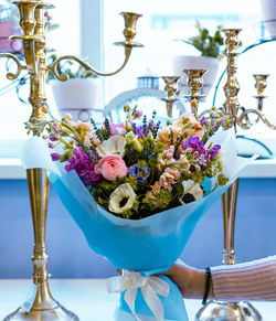 Close-up of hand holding flower vase