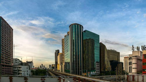 Buildings against cloudy sky