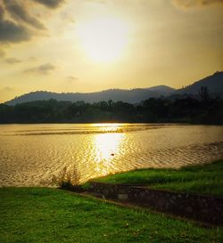 Scenic view of lake against sky during sunset