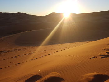 Scenic view of desert against sky during sunset