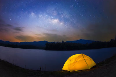 Scenic view of tent against sky at night