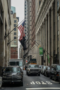 Cars on road amidst buildings in city