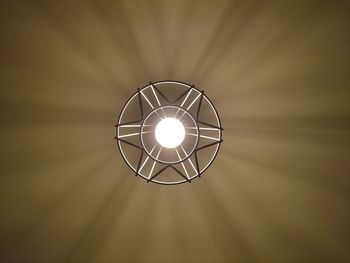 Low angle view of illuminated pendant lights hanging on ceiling