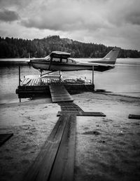 Jetty in lake against sky