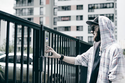 Man on railing in city