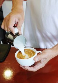 Midsection of man holding coffee