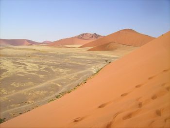 Tranquil view of desert against clear sky