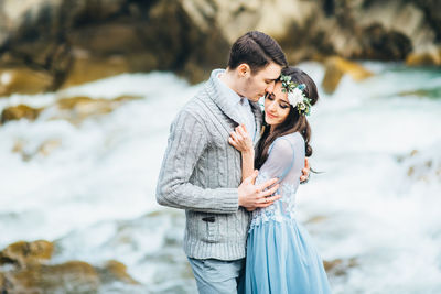 Young couple standing in water