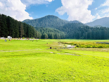 Scenic view of field and mountains against sky