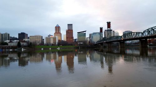 Bridge over river with buildings in background