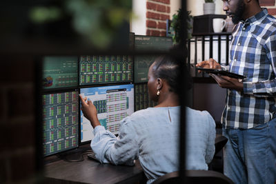 Business colleagues discussing while trading in office