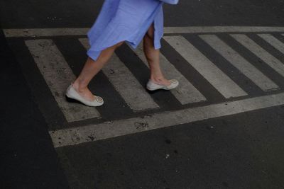 Low section of people standing on road