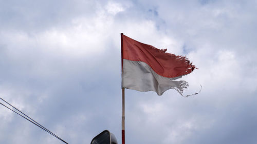 Low angle view of flag against sky