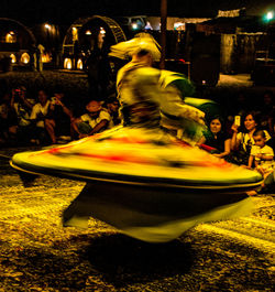 Blurred motion of illuminated carousel at night