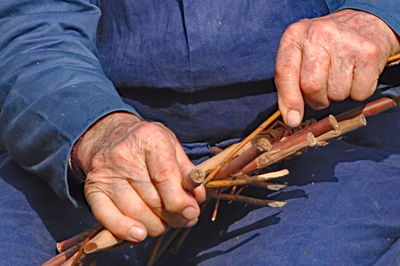 Cropped image of man holding mobile phone