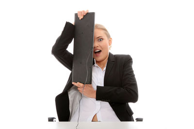 Young woman standing against white background