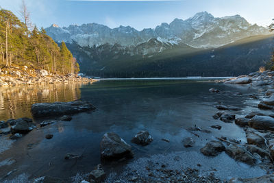 Scenic view of lake and mountains against sky