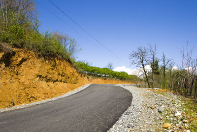 Empty highway and road in georgia during sunlight, blue sky and trees