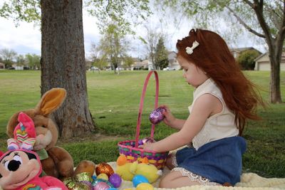 Rear view of women sitting on toy at park