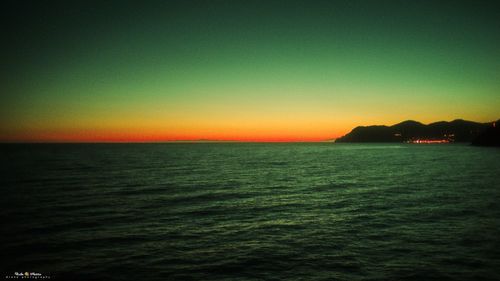 Scenic view of sea against clear sky during sunset