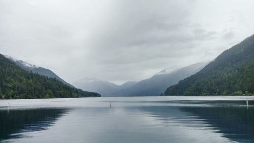 Scenic view of calm lake against mountain range