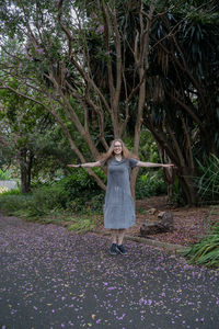 Woman standing by tree