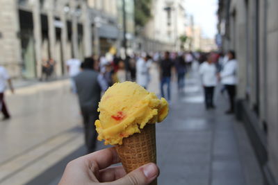 Cropped image of hand holding ice cream cone