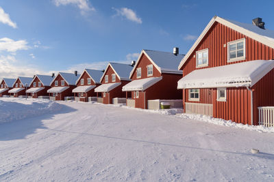 Row of houses and buildings against sky during winter