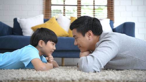 Siblings lying on floor