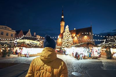 Rear view of people in city at night