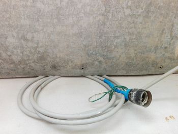 Close-up of cables against blue wall