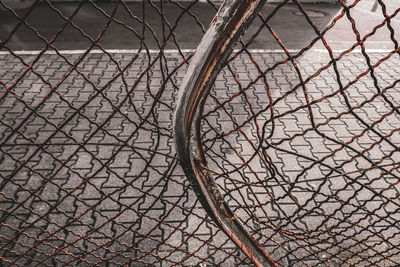 High angle view of chainlink fence in city