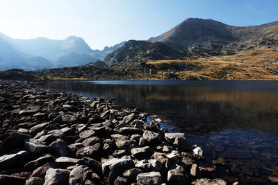 Scenic view of lake and mountains against sky