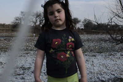 Portrait of girl standing outdoors