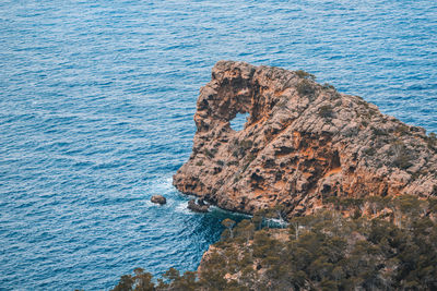 High angle view of rock formation in sea