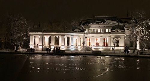 Building by wet street at night