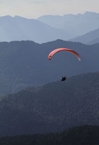 Man paragliding over mountains