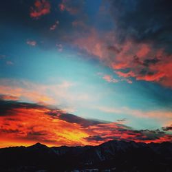 Scenic view of silhouette mountains against sky at sunset