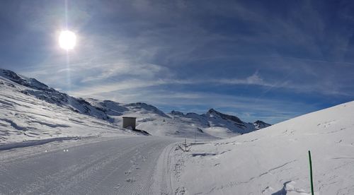 Scenic view of snow covered mountains against sky