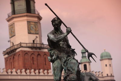 Low angle view of statue against historic building