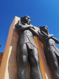 Low angle view of statue against blue sky