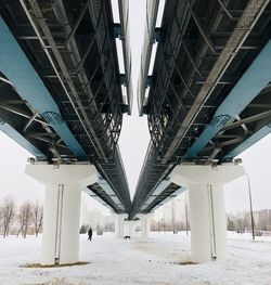 Bridge over snow covered city against sky