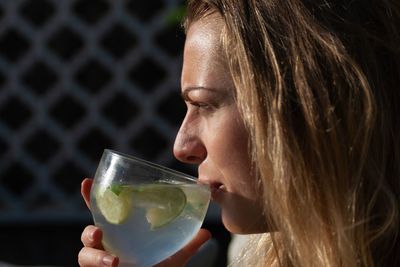 Close-up portrait of woman drinking glass