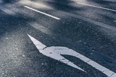 High angle view of arrow sign on road