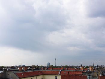 Buildings against cloudy sky
