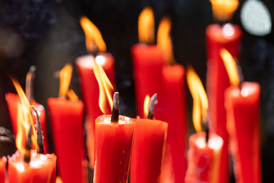 Close-up of lit candles in temple